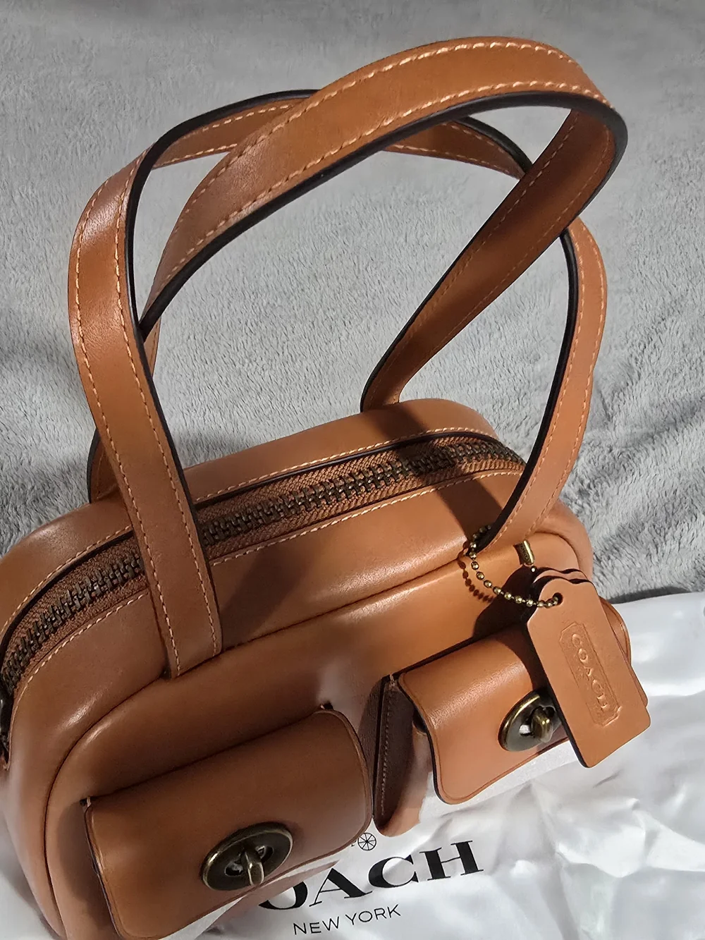 Coach hardware turn caramel
